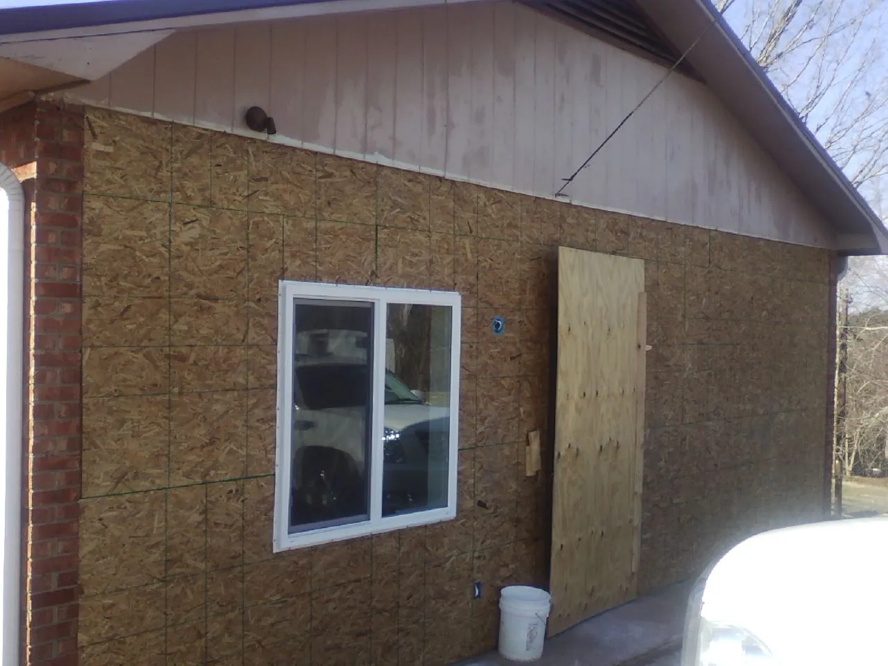 OSB sheathing on a garage addition wall before siding in Jeffersonville