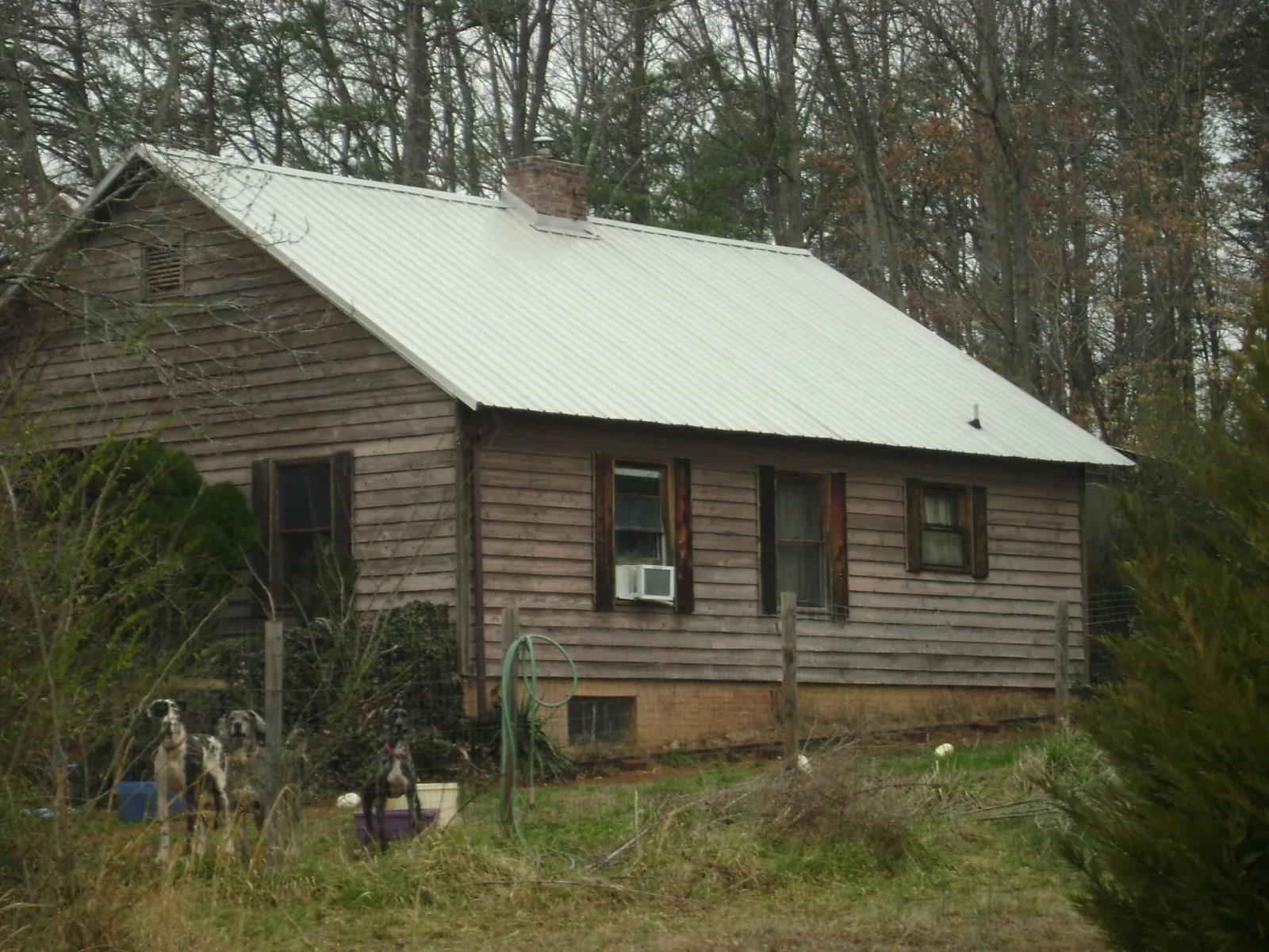 White metal roof on an old wood sided farmhouse, from a Metal Roof Installation job in Jeffersonville
